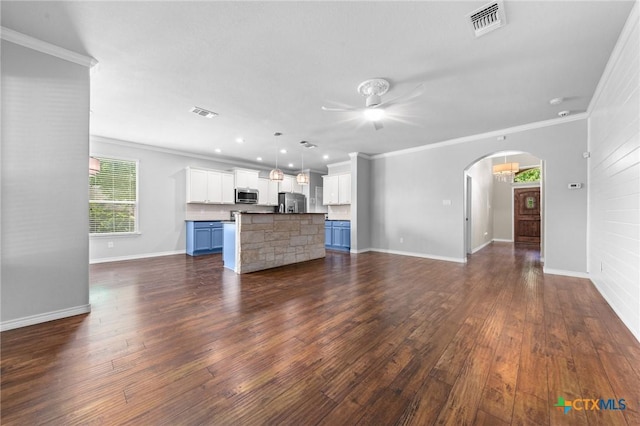 5705 Fenton Ln, Belton, TX 76513 - unfurnished living room with ceiling fan, crown molding, dark wood-type flooring, baseboards, and arched walkways