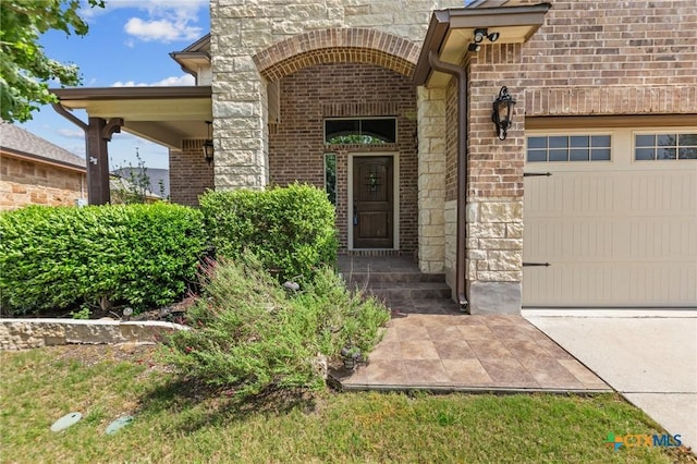 5705 Fenton Ln, Belton, TX 76513 - doorway to property with a garage, stone siding, brick siding, and concrete driveway
