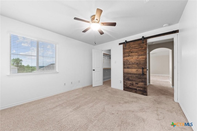 5705 Fenton Ln, Belton, TX 76513 - unfurnished bedroom with carpet flooring, arched walkways, baseboards, a spacious closet, and a ceiling fan