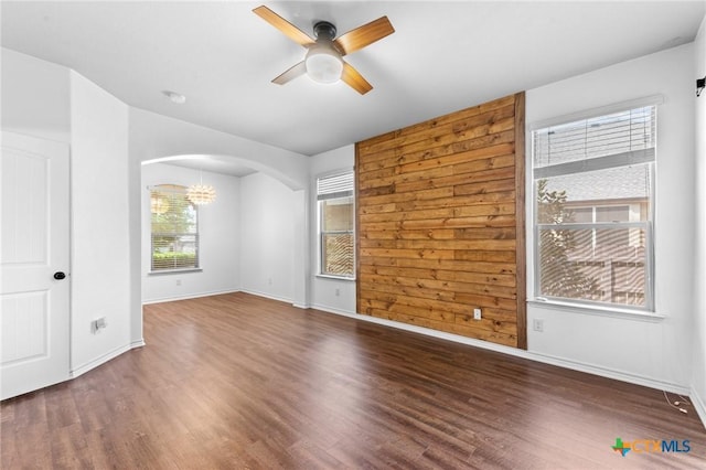 5705 Fenton Ln, Belton, TX 76513 - spare room with ceiling fan, arched walkways, wood finished floors, and baseboards