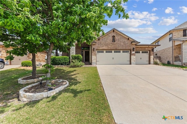 5705 Fenton Ln, Belton, TX 76513 - view of front of property with a front yard, a garage, concrete driveway, and brick siding