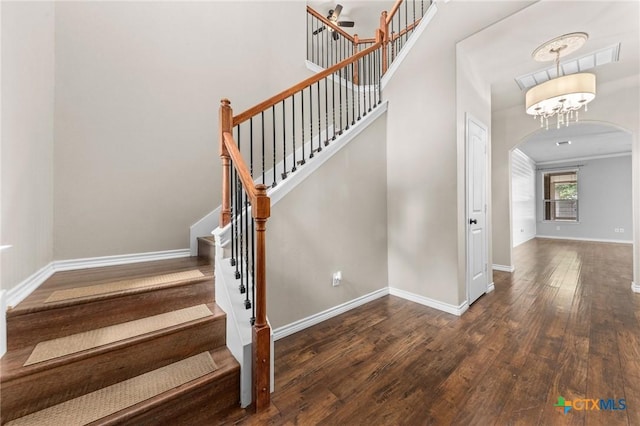5705 Fenton Ln, Belton, TX 76513 - staircase with arched walkways, wood finished floors, baseboards, and ornamental molding