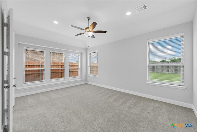 unfurnished room featuring vaulted ceiling, ceiling fan, and light colored carpet