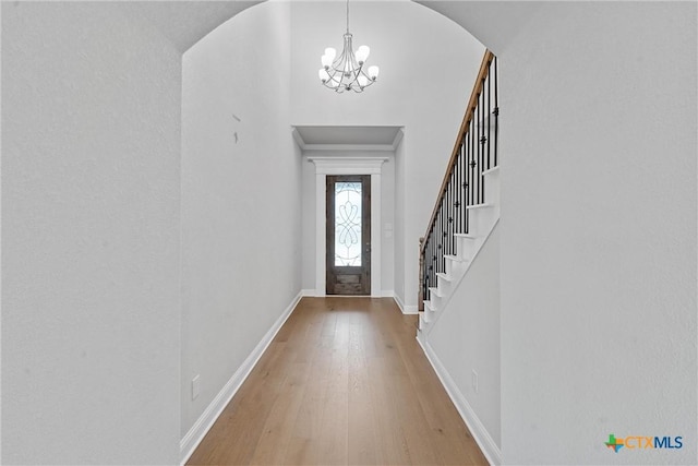 entrance foyer featuring a notable chandelier and hardwood / wood-style floors