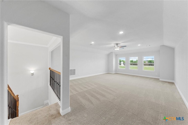 unfurnished living room featuring lofted ceiling, light colored carpet, and ceiling fan