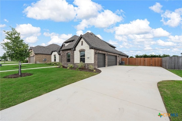 french country inspired facade with a front lawn and a garage