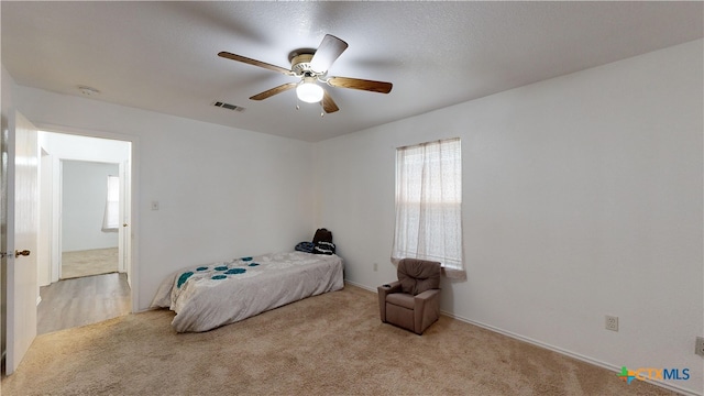 bedroom featuring light carpet and ceiling fan