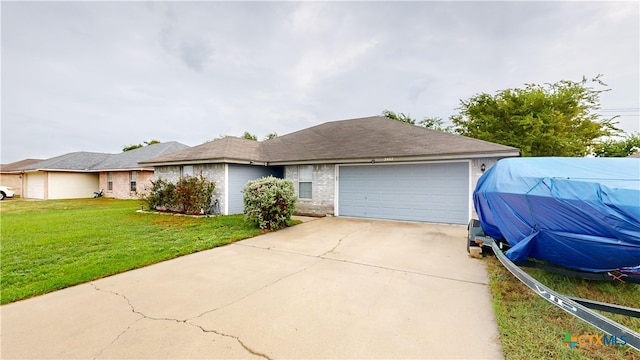 ranch-style house featuring a garage and a front lawn