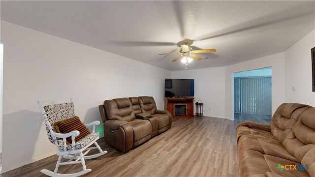 living room featuring ceiling fan and wood-type flooring