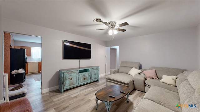 living room with ceiling fan and light hardwood / wood-style flooring