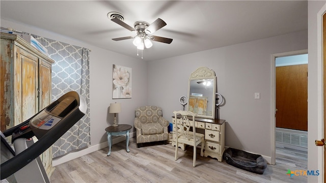 sitting room with ceiling fan and light hardwood / wood-style flooring