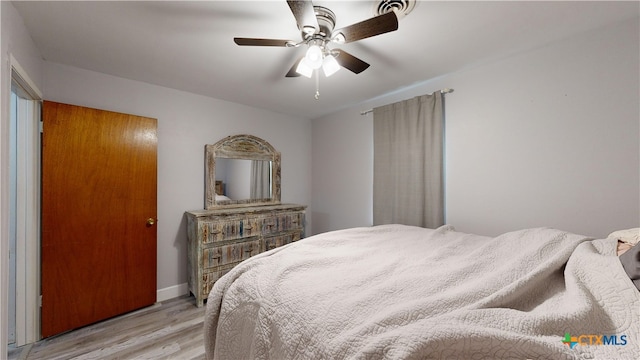 bedroom with ceiling fan and light wood-type flooring