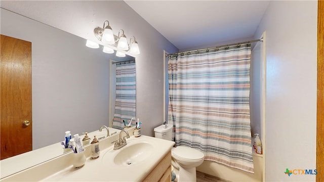 full bathroom featuring toilet, vanity, and shower / tub combo with curtain