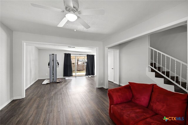 living room with ceiling fan and dark hardwood / wood-style floors