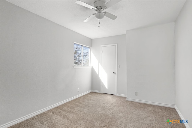 carpeted empty room with ceiling fan