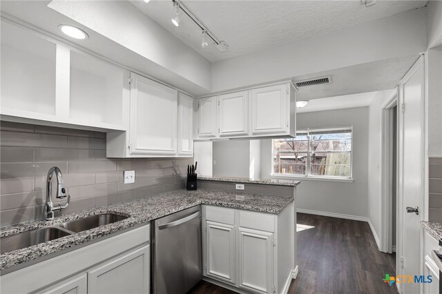 kitchen featuring light stone counters, stainless steel fridge with ice dispenser, electric range, and white cabinets