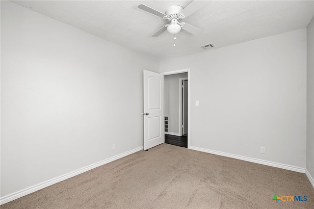 empty room with carpet floors and ceiling fan