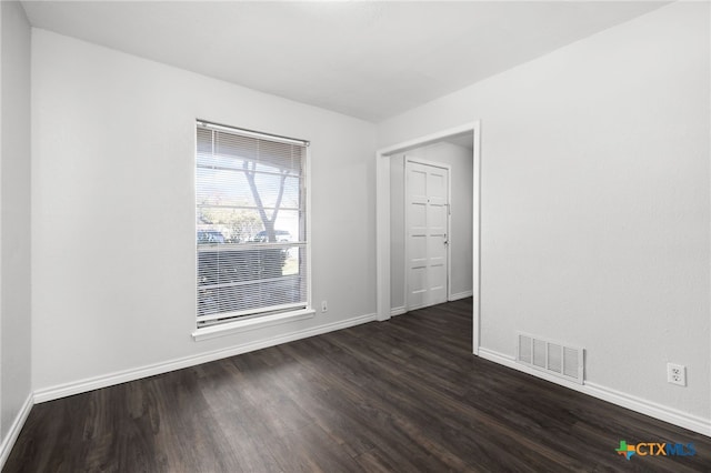 unfurnished room featuring dark hardwood / wood-style floors