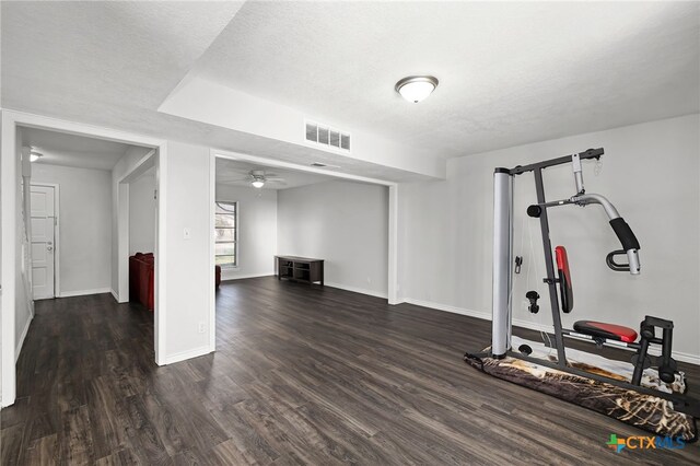 living room with ceiling fan, dark wood-type flooring, and a textured ceiling