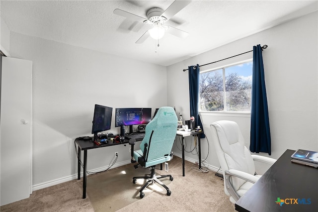 carpeted home office featuring ceiling fan and a textured ceiling