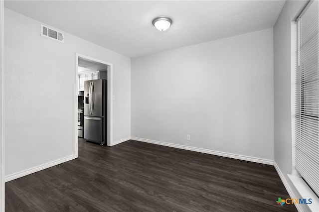 spare room featuring dark hardwood / wood-style flooring