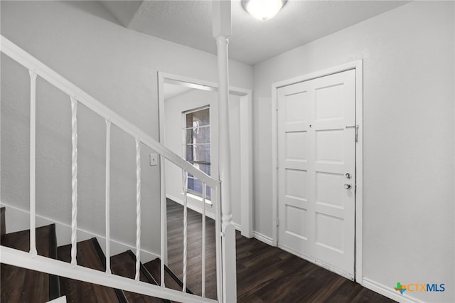 foyer with dark hardwood / wood-style flooring and decorative columns