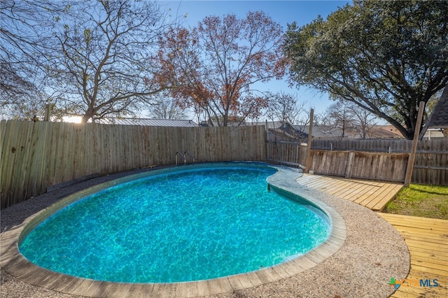 view of swimming pool with a deck