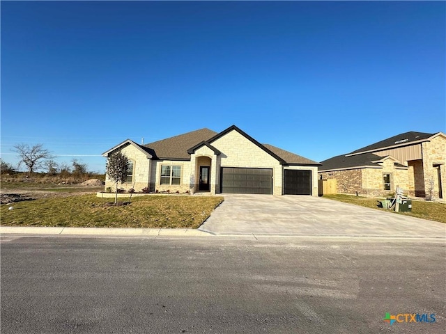 french provincial home featuring a garage