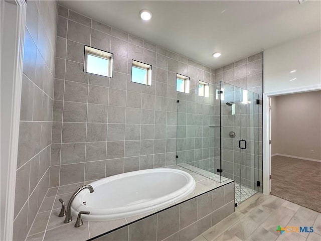 bathroom with tile patterned floors and independent shower and bath