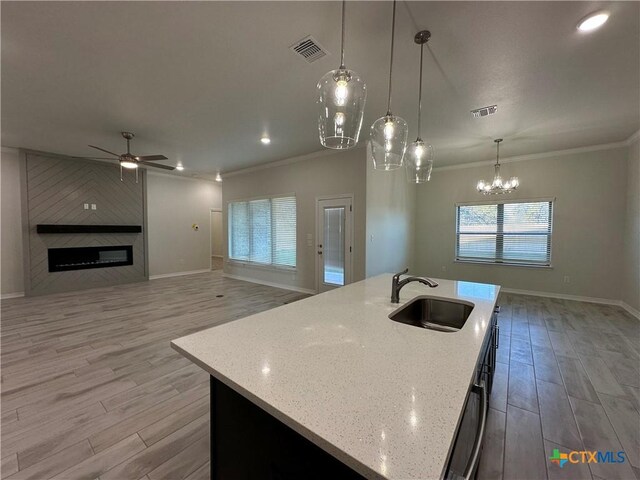 laundry room featuring cabinets, sink, light hardwood / wood-style flooring, washer hookup, and hookup for an electric dryer