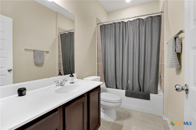 bathroom with tile patterned floors, vanity, toilet, and shower / bath combo with shower curtain