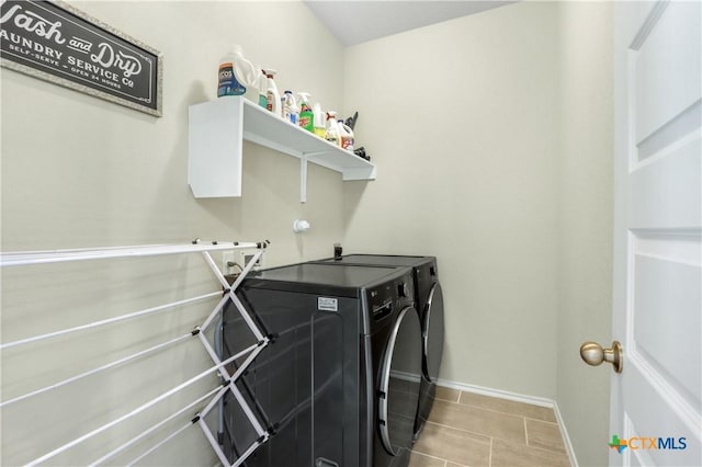 washroom with laundry area, baseboards, separate washer and dryer, and tile patterned floors