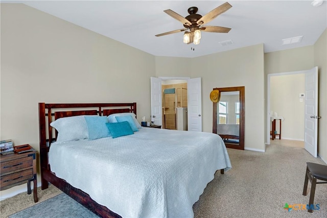 carpeted bedroom featuring a ceiling fan, visible vents, and baseboards