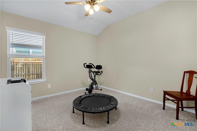 workout room featuring carpet floors, vaulted ceiling, baseboards, and ceiling fan