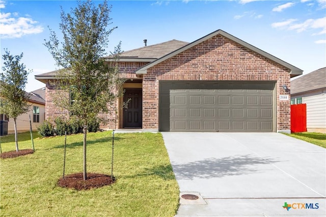 ranch-style house featuring a garage, a front yard, brick siding, and driveway