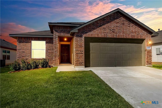 ranch-style house with an attached garage, brick siding, driveway, and a front lawn