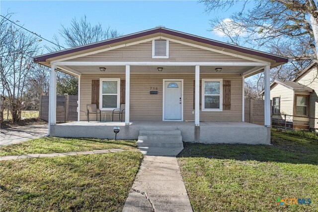 bungalow-style home featuring a porch and a front yard