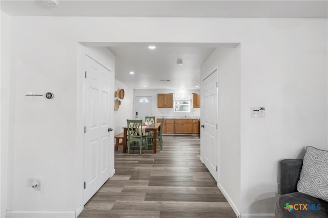 hall with dark hardwood / wood-style flooring