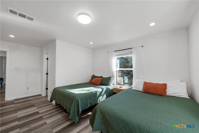 bedroom with wood-type flooring