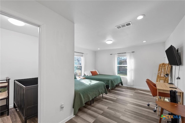 bedroom with hardwood / wood-style flooring