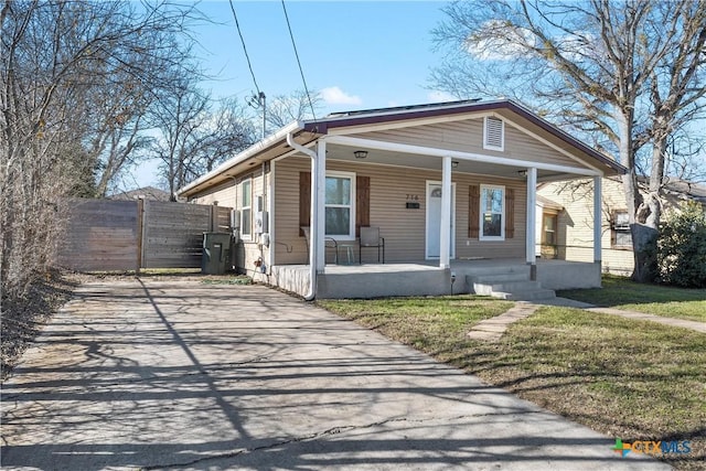 bungalow-style home featuring a porch and a front yard