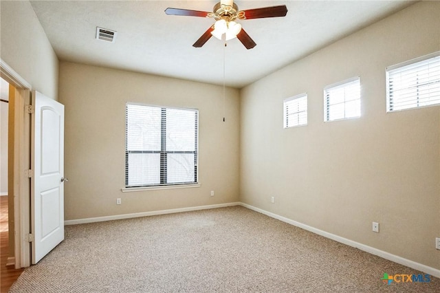 empty room featuring light carpet and ceiling fan