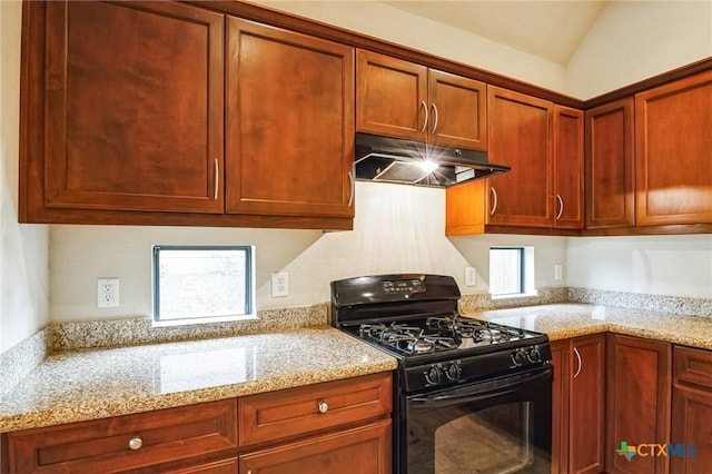 kitchen featuring light stone countertops, lofted ceiling, and black range with gas cooktop