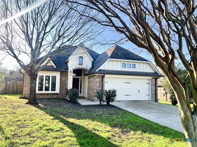 view of front of home with a garage and a front lawn