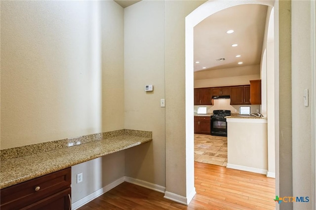 corridor with sink and light hardwood / wood-style flooring