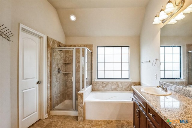 bathroom featuring an inviting chandelier, lofted ceiling, independent shower and bath, and vanity