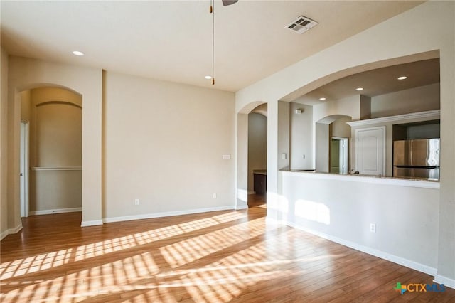 unfurnished room with wood-type flooring and ceiling fan