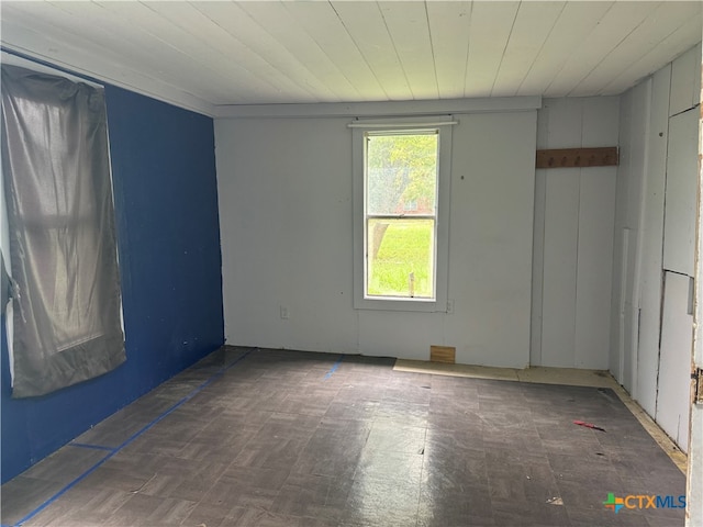 unfurnished room with wooden ceiling