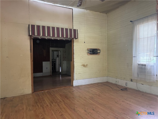 spare room with wood-type flooring