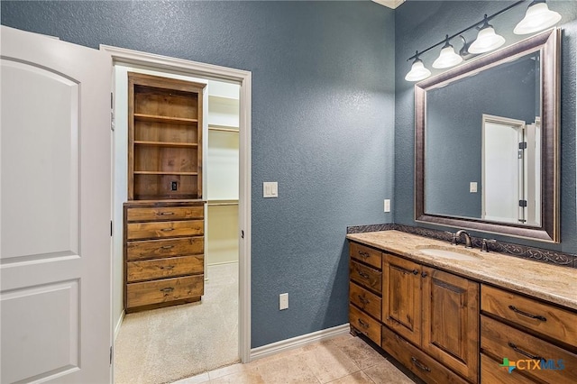 bathroom featuring tile patterned flooring and vanity